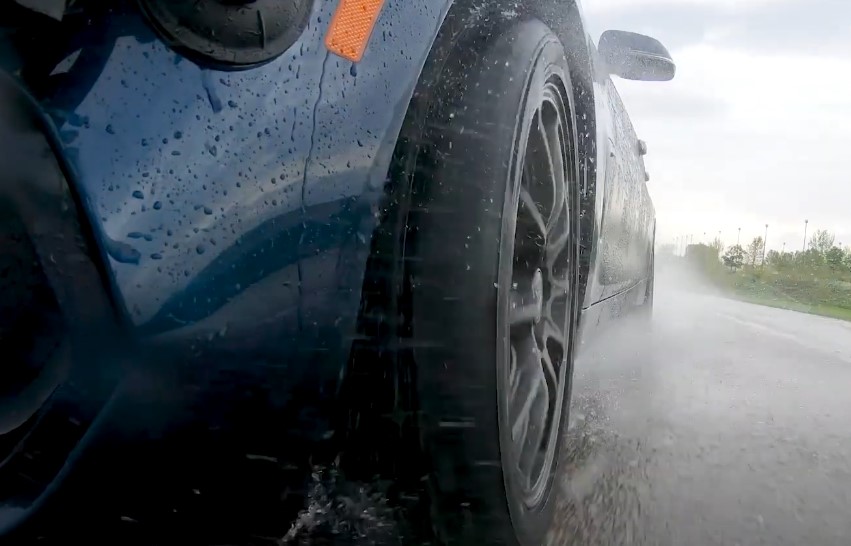 Close up view of a Bridgestone Potenza tire on a wet road