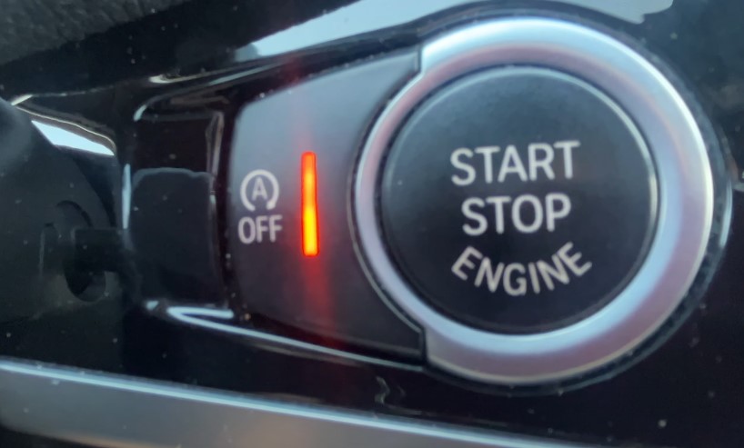 Close up view of a start/stop button inside a car