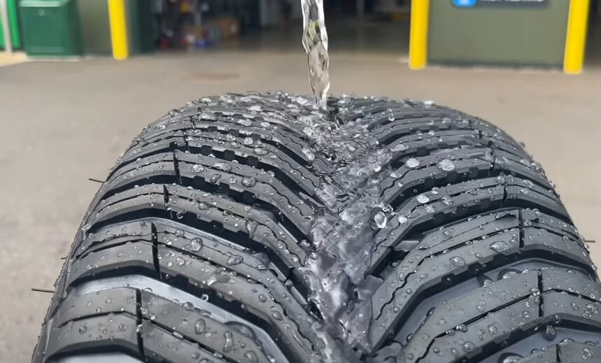 Close up view of a water being poured on a car tire