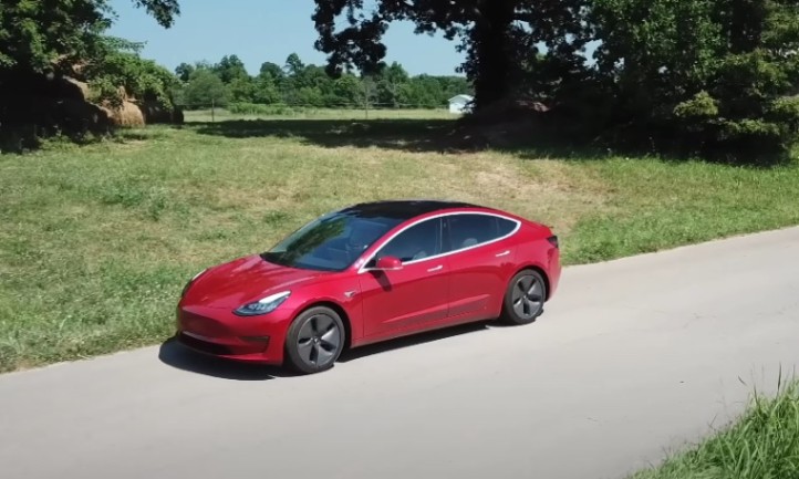 Red Tesla car on the road