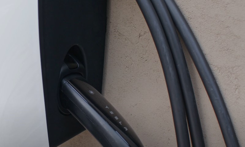 Close up view of a white Tesla wall connector