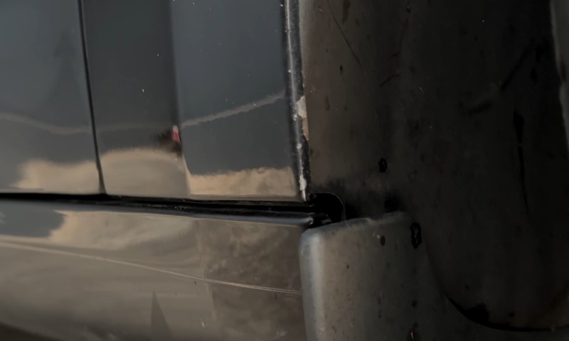Close-up view of the side of a car, highlighting paint depreciation