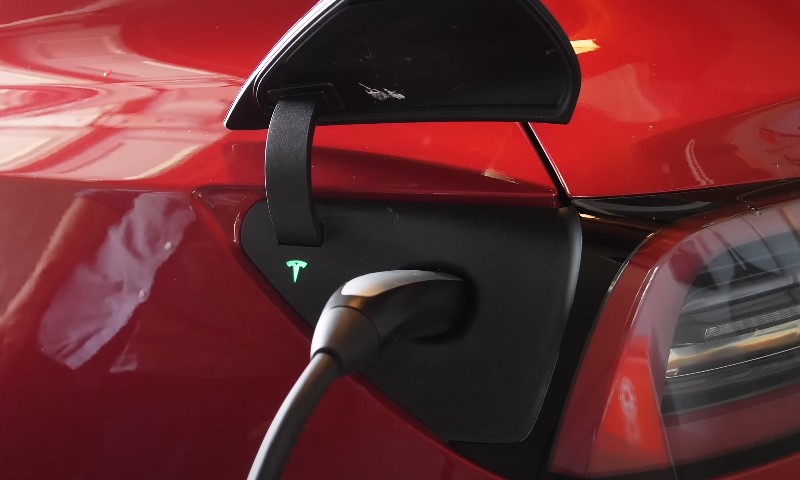 Close up of a red Tesla car during charging process