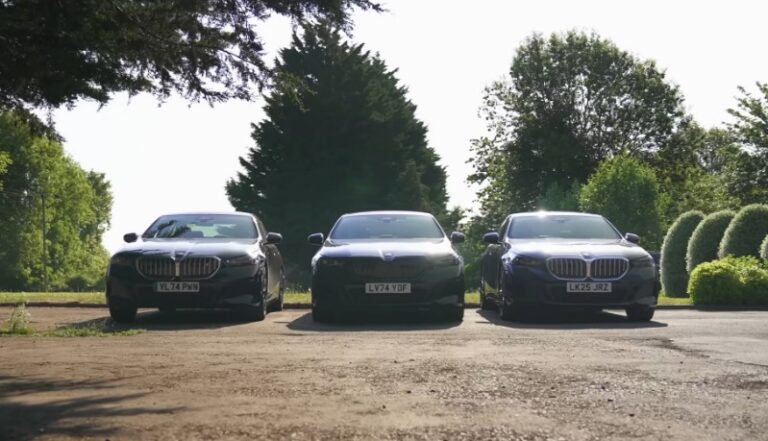 Three BMW cars parked in a row on a driveway